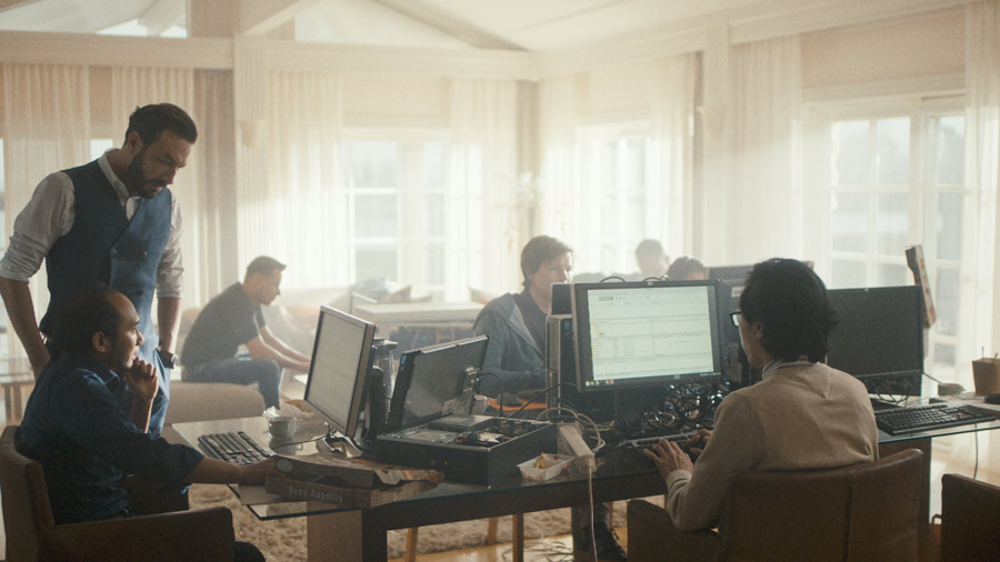 Film still: an airy room with hackers and computer equipment