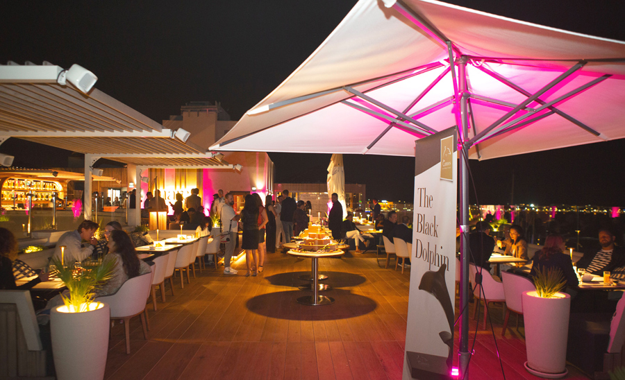 View into an open-air bar in Cannes at night